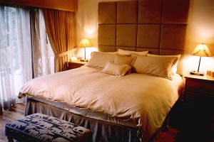  master bedroom with king bed, private bathroom and patio door to hot tub